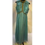 A 1970s 'California' aquamarine silk georgette evening dress with gold braiding, size 12 and a