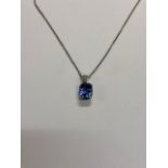 A cushion-cut sapphire pendant with diamond set hanger, white metal set, unmarked and untested, on