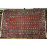 A Turkish design handmade rug, the field of three rows of guls on red ground, 198 cm x 129 cm