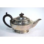 An oval silver bachelor teapot with Gothic-style embossed rim and reeded foot, Charles Edwards,