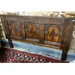 An antique three-panel frieze with inlaid and carved arch decoration, later mounted as a bed-head,