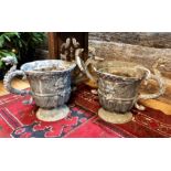 A good pair of 18th century lead urns, the urn form bodies with cabochon moulded rims over winged