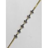 An 18ct yellow gold bracelet set with sapphires and diamonds in the form of leaves, approx 7g all in
