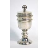 A hammered silver small travelling Holy Communion chalice, the detachable wafer box top with cross
