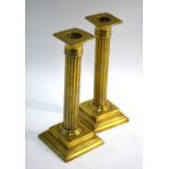A pair of early 19th century cast brass baluster candlesticks, 26 cm high, to/w a pair of