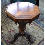 A Victorian rosewood work table, the octagonal hinged top enclosing a well fitted fabric and paper
