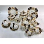 A Victorian Staffordshire gilded china tea and coffee service decorated with alternating panels of