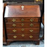 A George III mahogany bureau, the fall enclosing a fitted interior over four long graduated drawers,