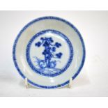 A small Chinese Export blue and white dish, decorated with a pine tree; 10 cm diameter; with