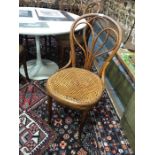 A set of six vintage Thonet bentwood cane seat cafe chairs, some retaining makers labels to