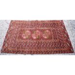 An old Afghan/Uzbek Turkmen rug, circa 1920, the triple gul design on red-brown ground, 195 x 133 cm