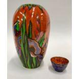 A Crown Devon ovoid lustre case, orange ground decorated with stylised flowers and leaves to/w a