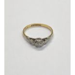 A single stone diamond ring, the high claw set brilliant cut diamond with carved shoulders, yellow