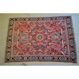 An old Persian Mahal rug, the centre medallion design in colours on pale red ground, 1.92 x 1.30 m