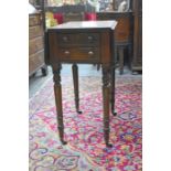 A 19th century mahogany drop leaf table with two drawer to one end opposing dummy drawers, raised on