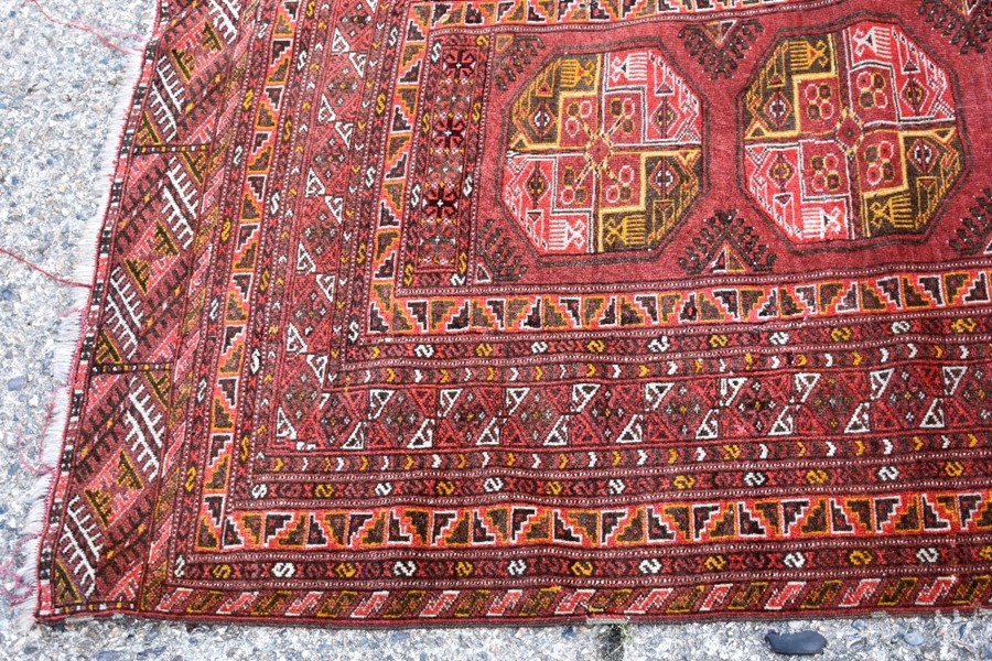 An old Afghan/Uzbek Turkmen rug, circa 1920, the triple gul design on red-brown ground, 195 x 133 cm - Image 8 of 9