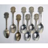 A matched set of eight heavy quality silver teaspoons, the finials worked with the arms of the
