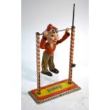 A German Arnold tinplate 'Jimmy' acrobat clown with ratchet mechanism composite figure with cloth