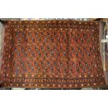 An antique Afghan-Turkmen rug, the two rows of stylised guls on re-brown ground, circa 1920 147 x 99