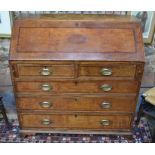 A George III rosewood cross-banded oak bureau, the fall centred by an inlaid shell motif enclosing
