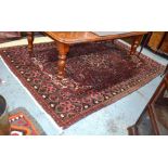 A Turkish carpet, the centre medallion design on brown-red ground, 305 cm x 205 cm