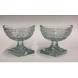A pair of regency table salts of navette form raised on lozenge shaped star cut bases, 12 cm high (