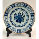 A Dutch Delft blue and white plate painted in the Kraak style with a figure of Ceres to the