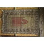 An antique Anatolian prayer rug, the geometric design in beige-camel tones on brown-red ground,  1.