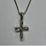 A white metal diamond-set stylised cross with snake-link chain stamped 925