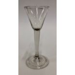 An 18th century cordial glass with round funnel bowl, plain stem, conical fold over foot and rough