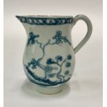 A small 18th century blue and white pearlware jug painted with a Chinoiserie scene with pagoda,