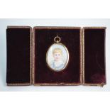 A late Victorian oval portrait miniature on ivory of a young boy, in glazed gilt pendant frame,