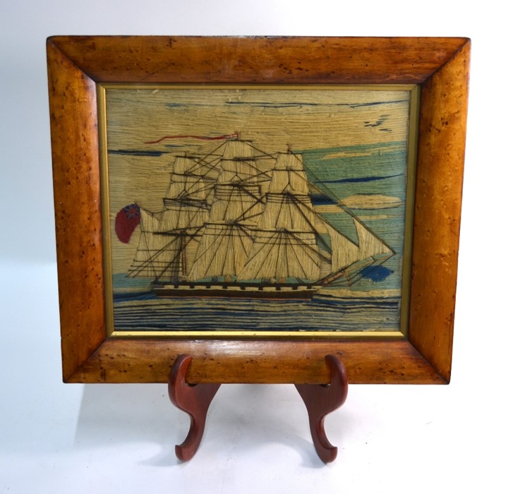 A 19th century wool-work picture of a three-masted 18-gun sailing ship, in glazed maple frame, 35