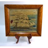 A 19th century wool-work picture of a three-masted 18-gun sailing ship, in glazed maple frame, 35