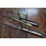Two sets of early 19th century brass pocket guinea-scales with folding wooden cases
