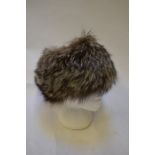 A charcoal grey tipped white fox fur hat with black suede crown, retailed by Femina Furs, LondonGood