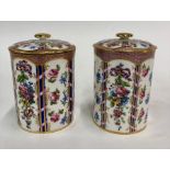 A pair of Sevres 19th century porcelain cylindrical pots and covers richly enamelled with panels