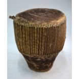 A vintage African drum, hide and rope embellished, 33 cm dia. c 36 cm h