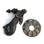 A bronze 'Merman' door knocker the roundel backing cast with 'wind putti', 20 cm high