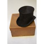A vintage black silk top hat retailed by City Cork Hat Company, 454 Cheapside, 53 cm