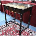 A 17th/18th century oak side table with frieze drawer, raised on a turned joint frame united by a