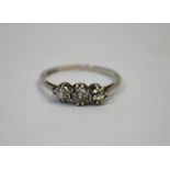 A three-stone old cut diamond ring, white gold set, size RThe central diamond with crack breaking