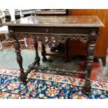 A 19th century carved oak side table, the all-round moulded edge top over a frieze drawer, raised on