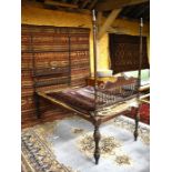 An antique Indian hardwood opium bed, the four post frame with spindle turned gallery ends, 198 cm x