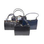 A collection of three black and one navy blue leather vintage ladies' handbags comprising; a black