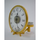 An American Waltham Clock Co. night clock, the opaque glass dial within a satin brass bezel and
