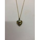 A pave-set diamond heart shaped pendant on diamond set hanger, the reverse with heart shaped open