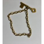 A yellow gold chain link bracelet with Gothic style key attached, approx 8.8g (excluding key)