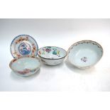Three Chinese Export bowls, all decorated with floral designs; the largest 26 cm diameter and the