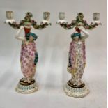 A pair of porcelain twi branch candelabra with figural stems in the form of classical women with